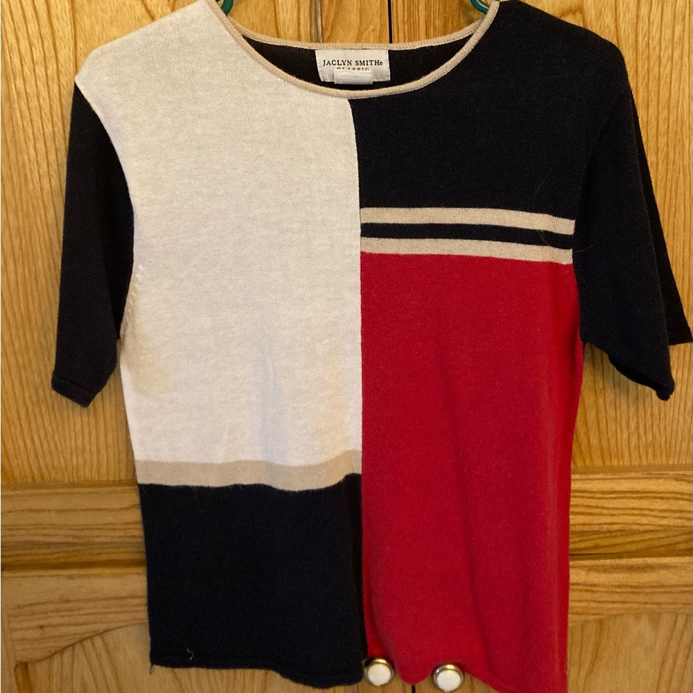 White, blue and red sweater.